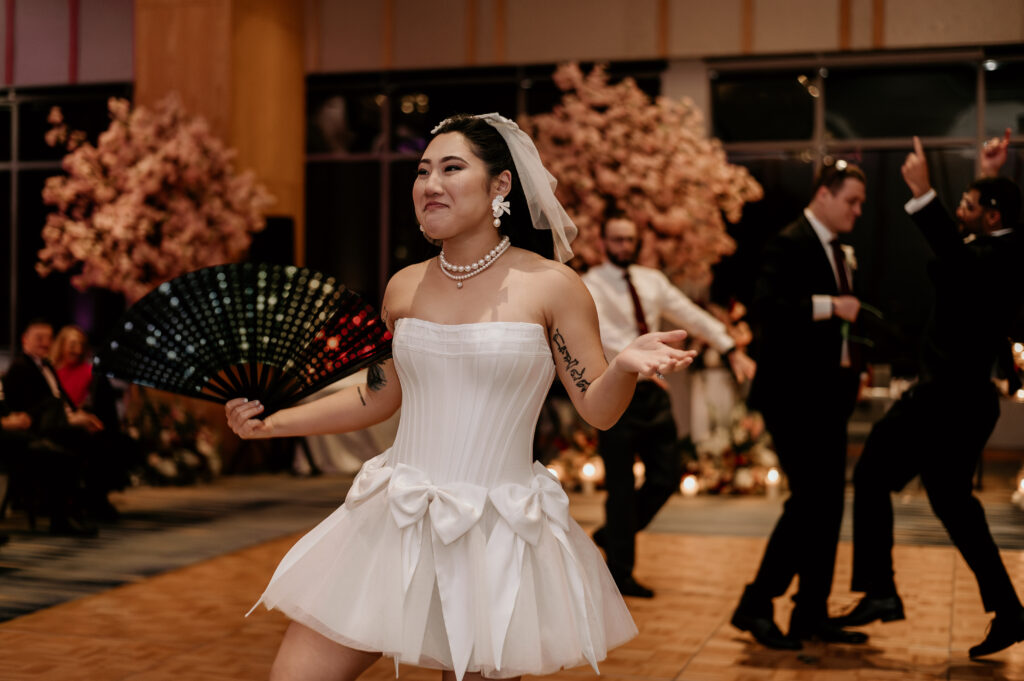 Bride dancing in her short party dress at the Four Seasons