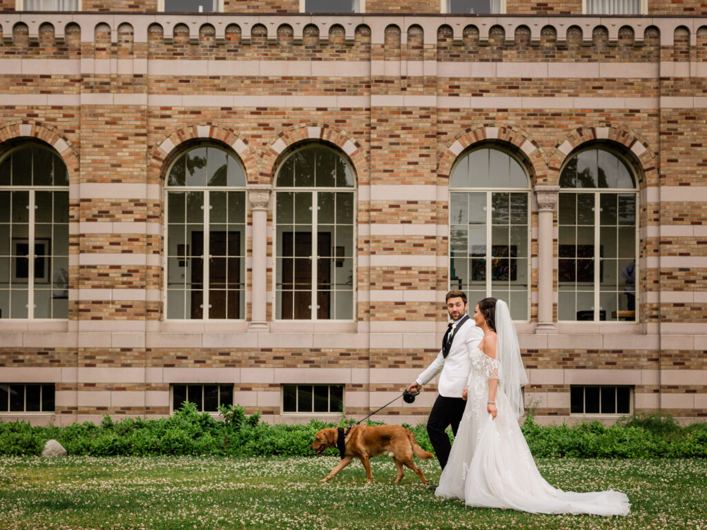 bride and groom walking with dog a t st. edwards lodge