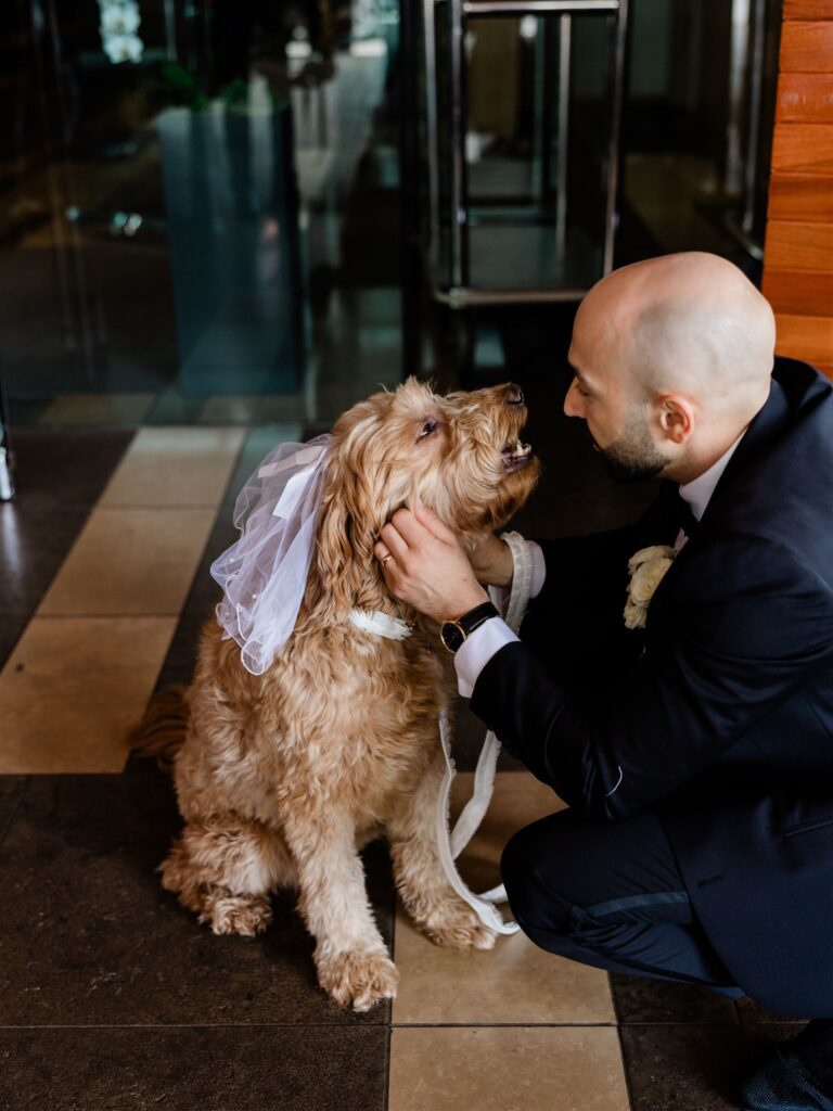 Groom and dog outside of Four Season's Seattle