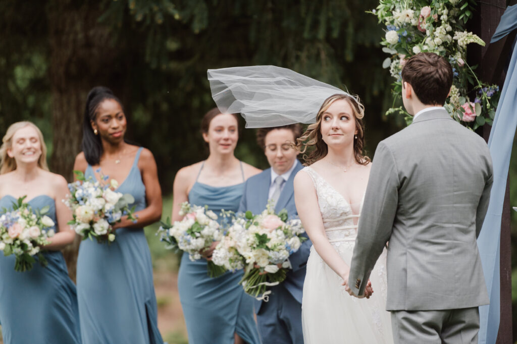 Shoulder length veil flying in the wind at trinity tree farm prologue events wedding