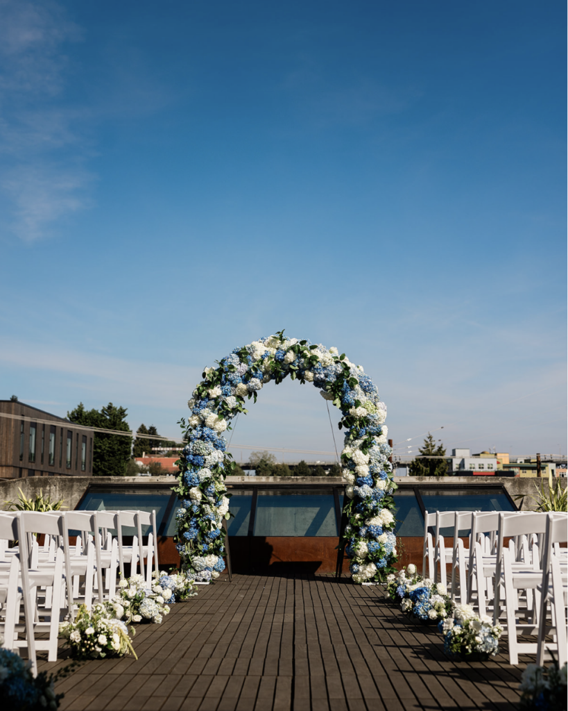 Ceremony with hydrangea arch at fremont foundry
