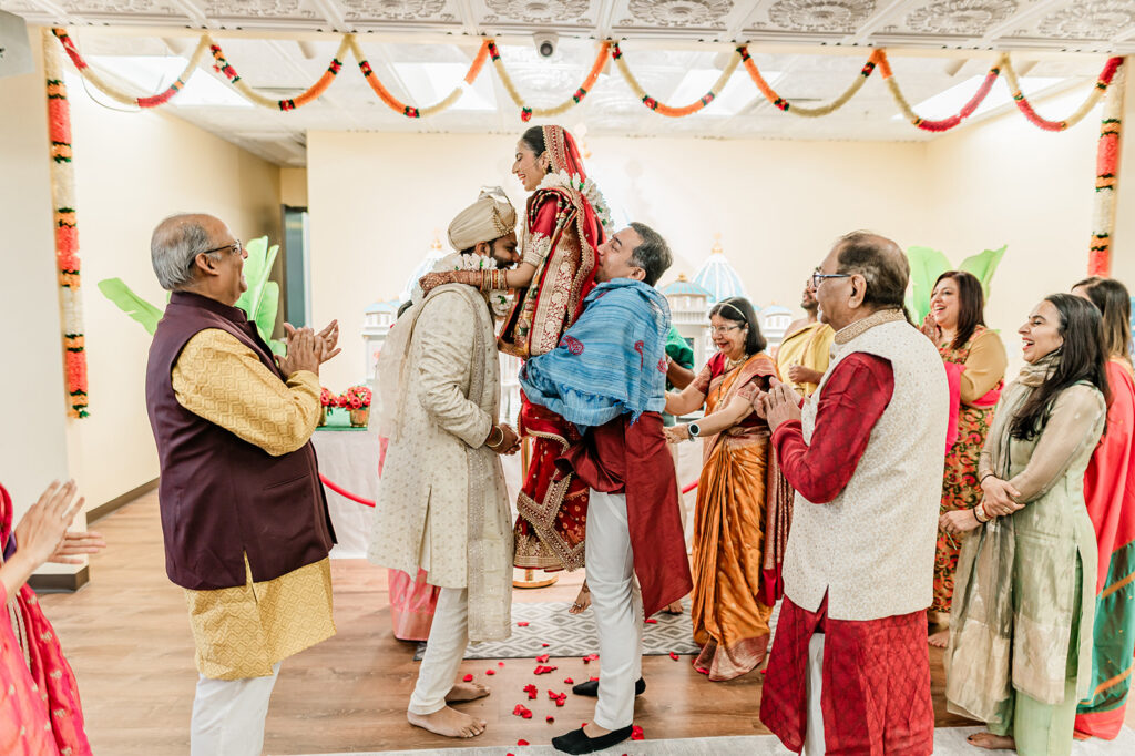 bride and groom adding a jaimala